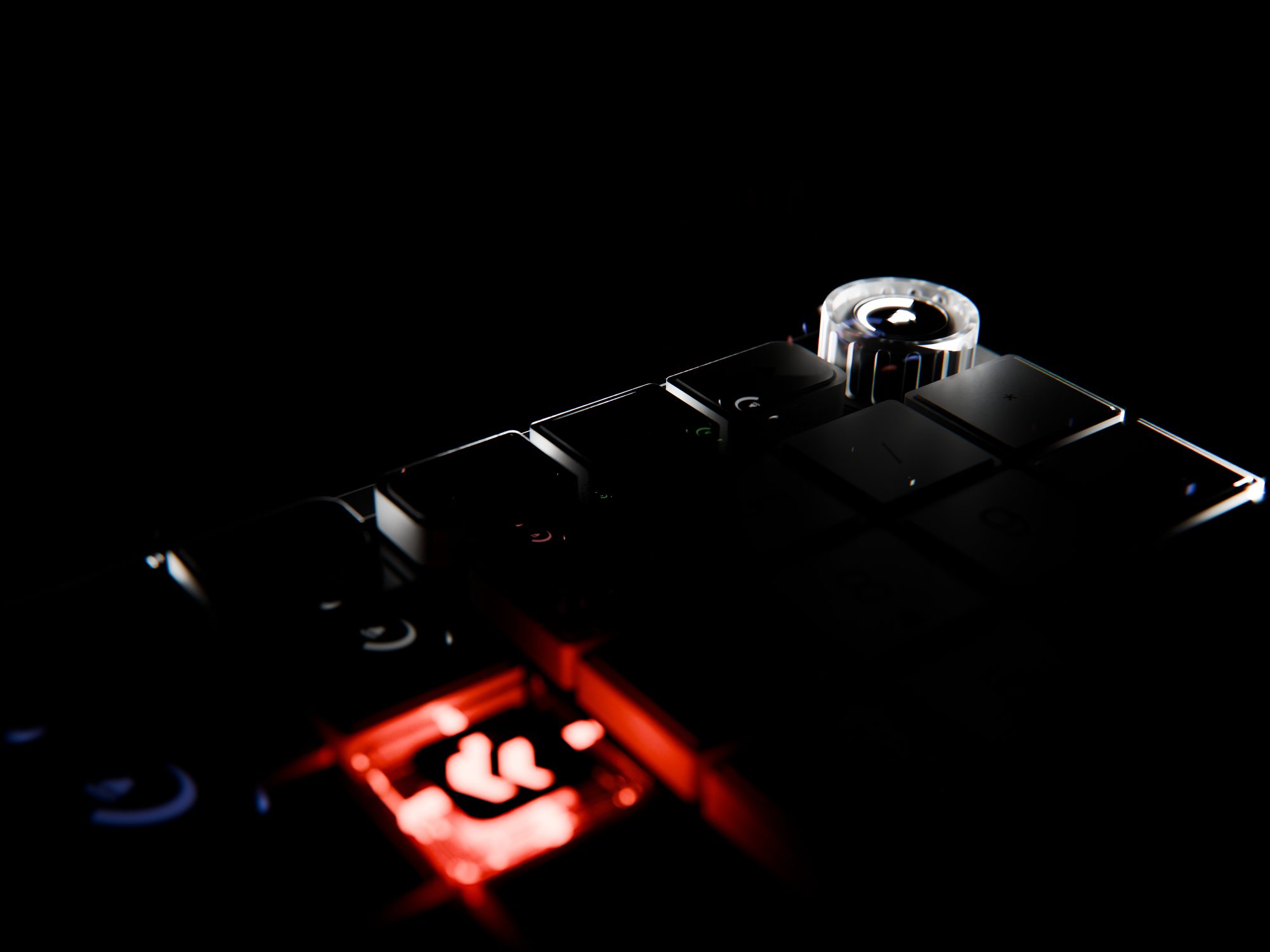 Close-up of a dark keyboard with a glowing orange Cooper key